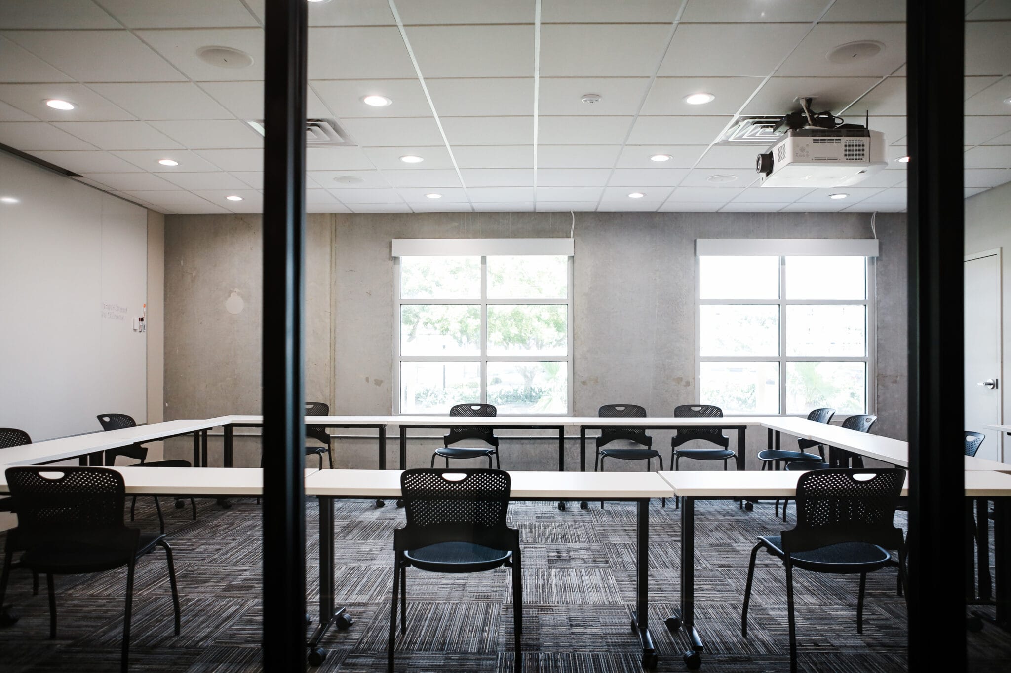 A large assembly room with multiple screens