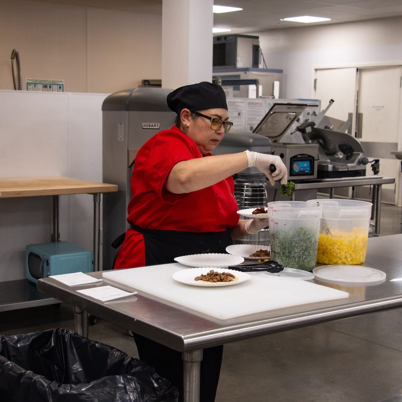 A Catapult kitchen incubator member plating catering food.