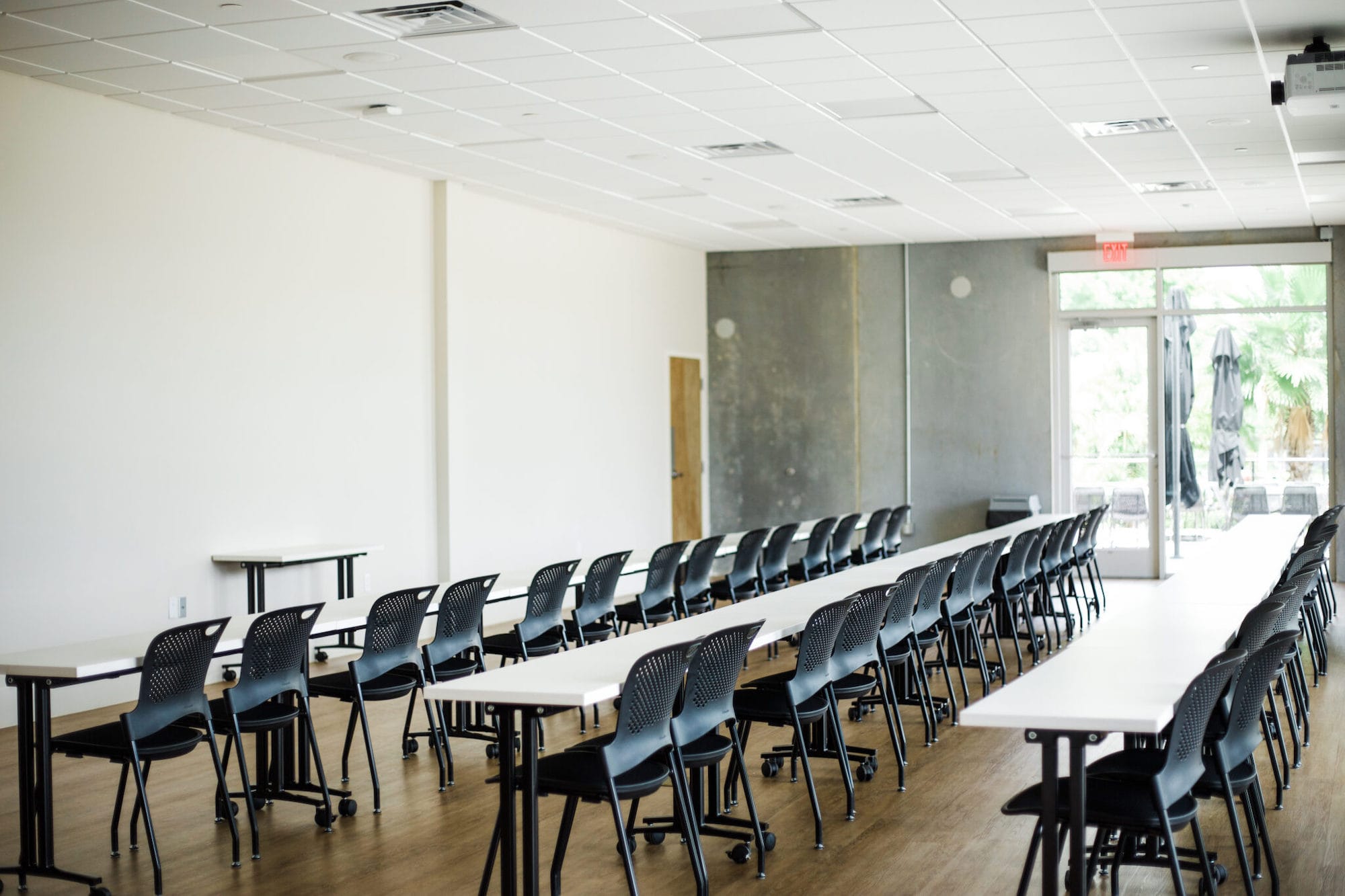 A large assembly room with multiple screens