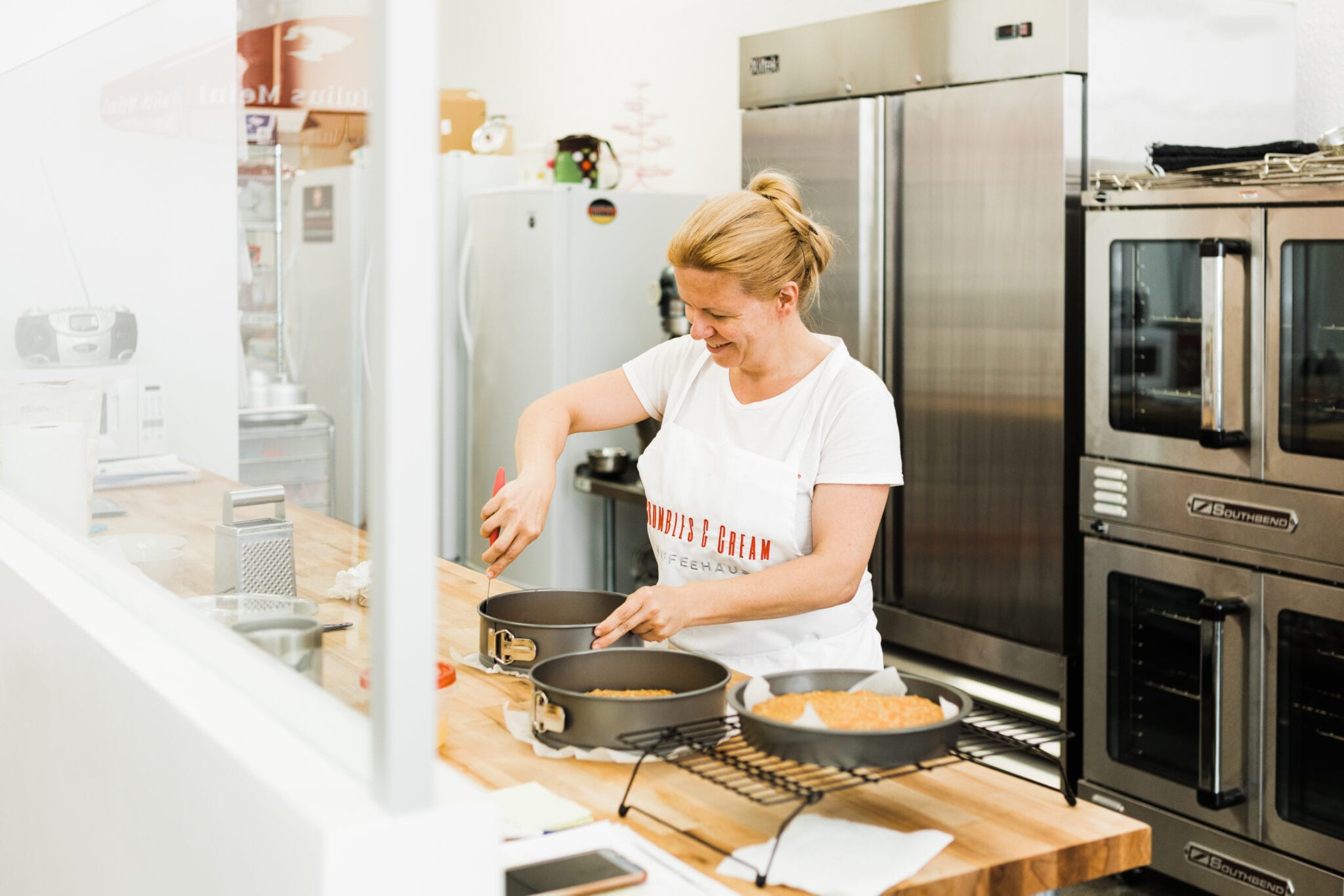 The Crumbles and Cream owner working in the kitchen.